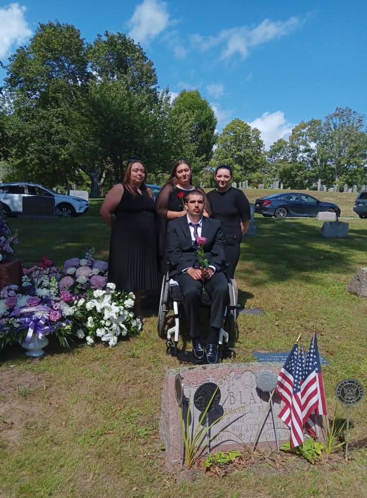 Kylee's siblings standing at her grave