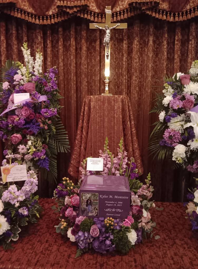 Wide funeral photograph of Kylee's urn and flowers