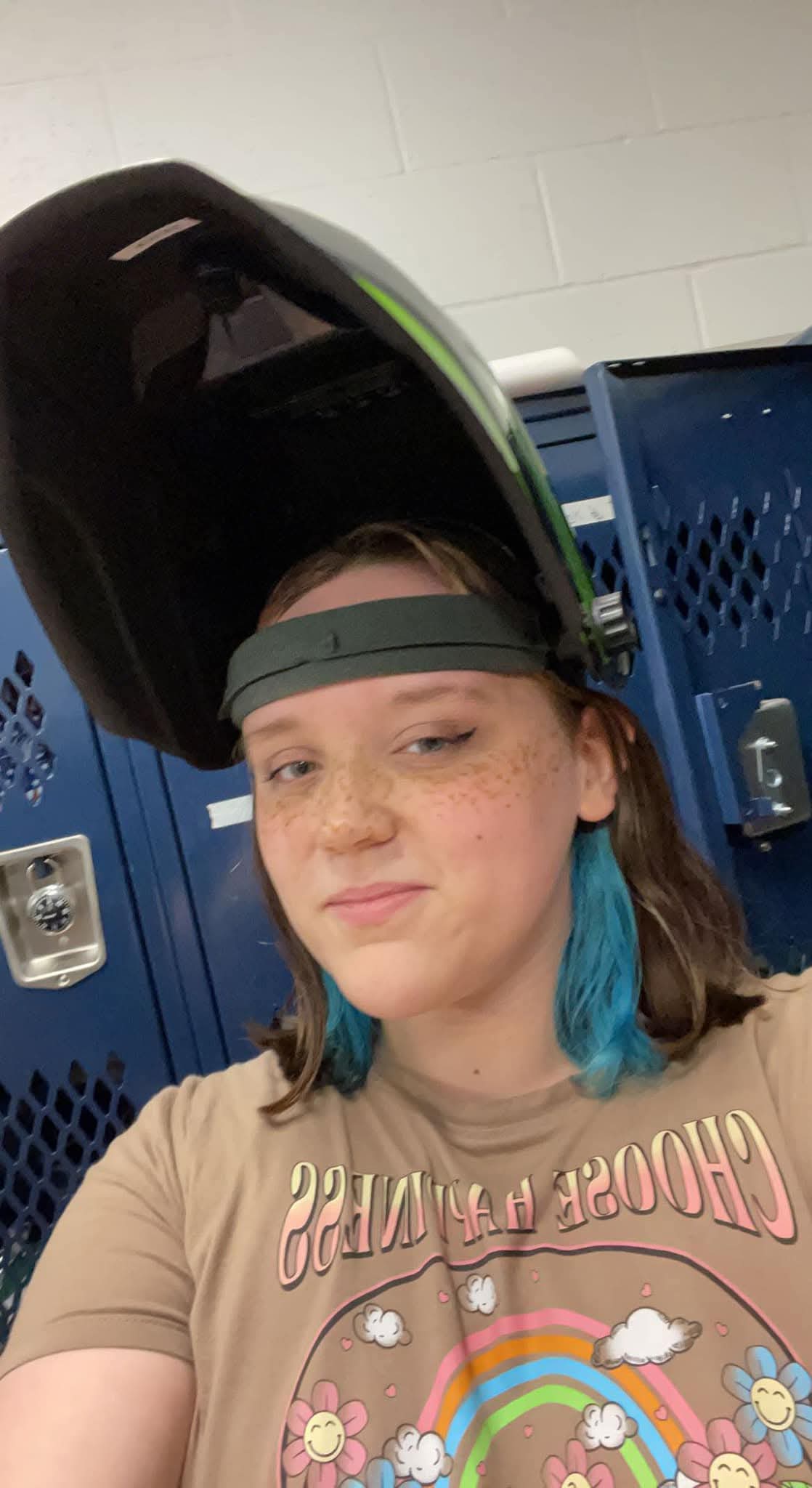 Kylee wearing a welding helmet